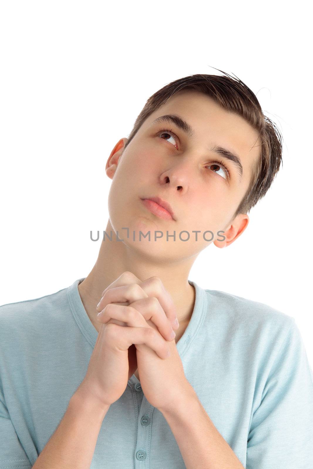 A boy praying and looking heavenward.