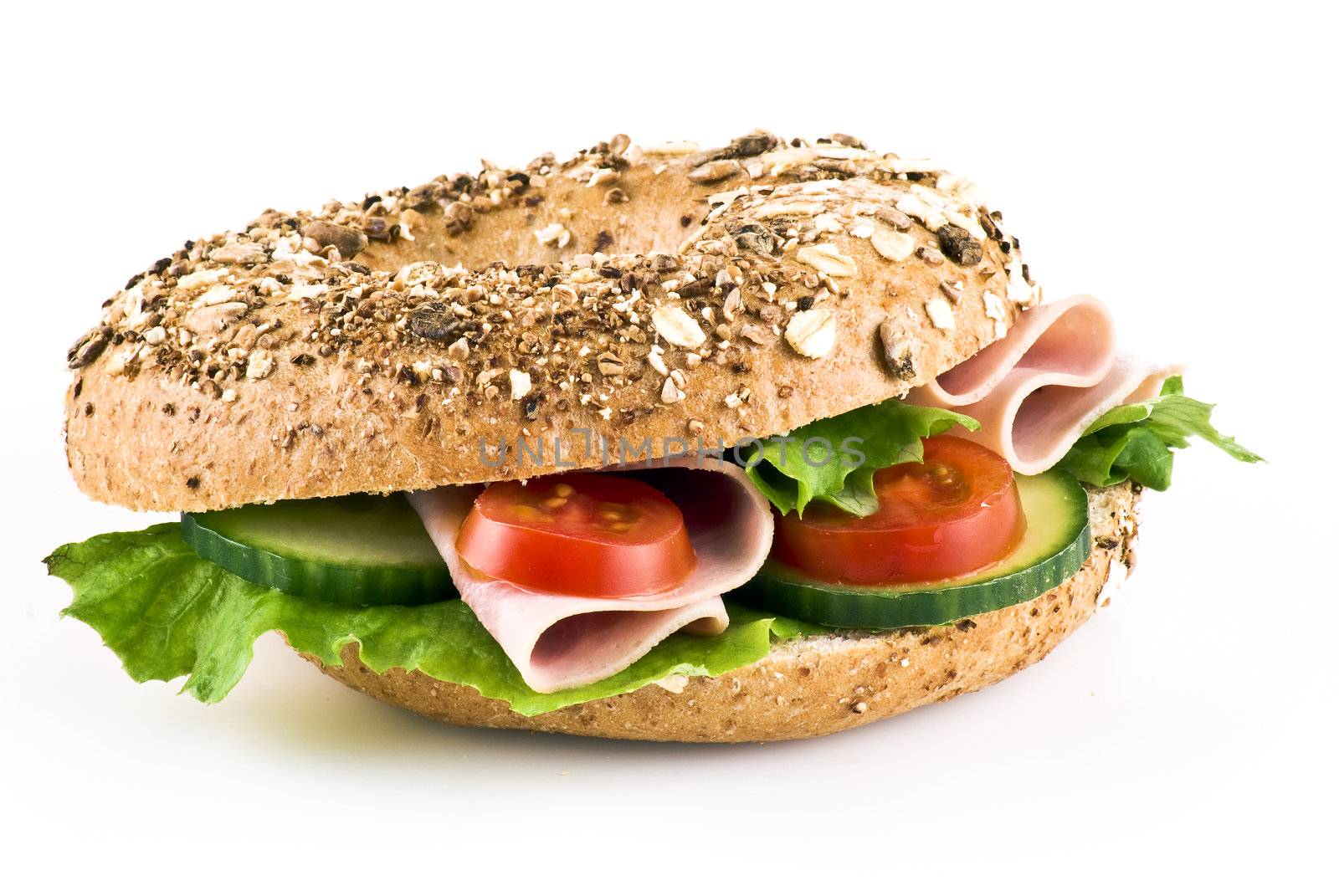 Freshly made sandwich with ham and vegetables over white background