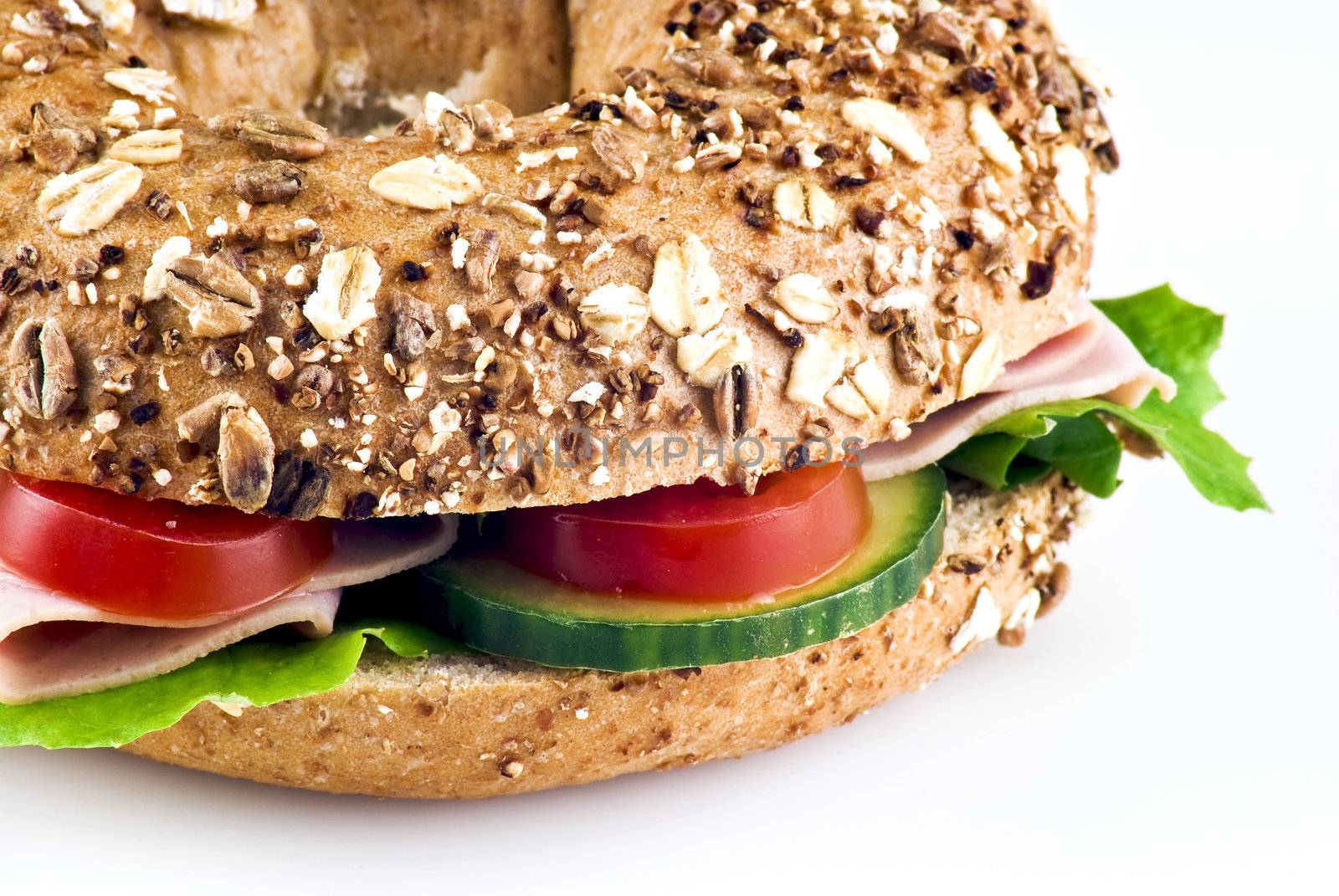 Freshly made sandwich with ham and vegetables over white background