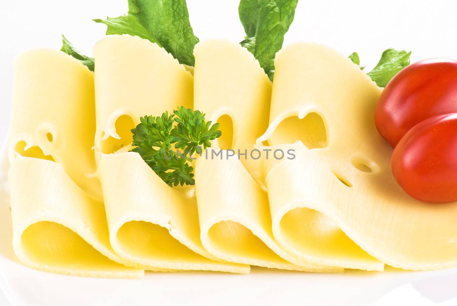 Sliced cheese with cherry tomatoes and lettuce