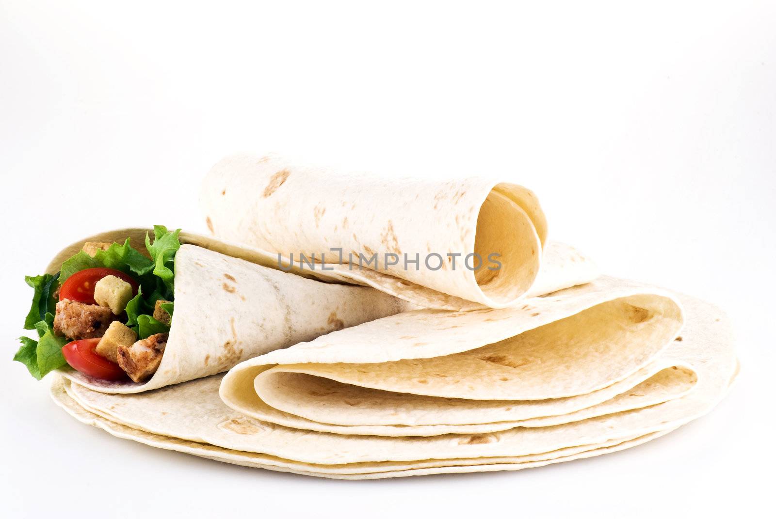 Tortilla filled with lettuce chicken tomatoes and cucumber with plain tortillas