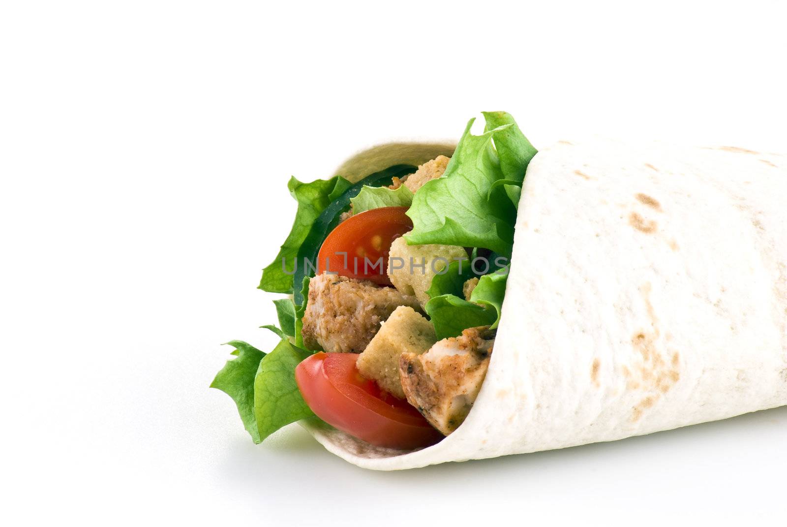 Tortilla filled with lettuce chicken tomatoes and cucumber