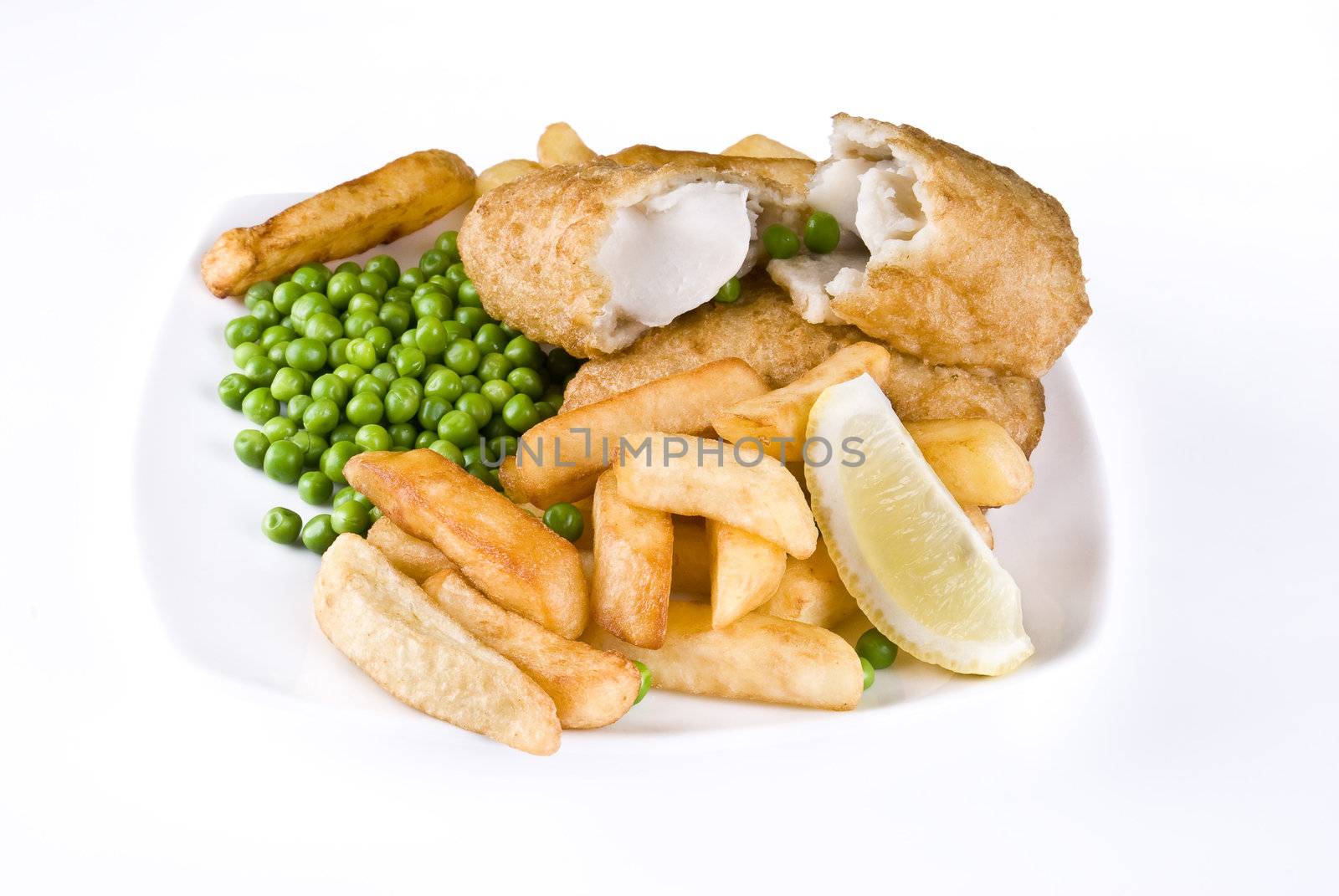 Fried fish and chips with lemon and peas - isolated