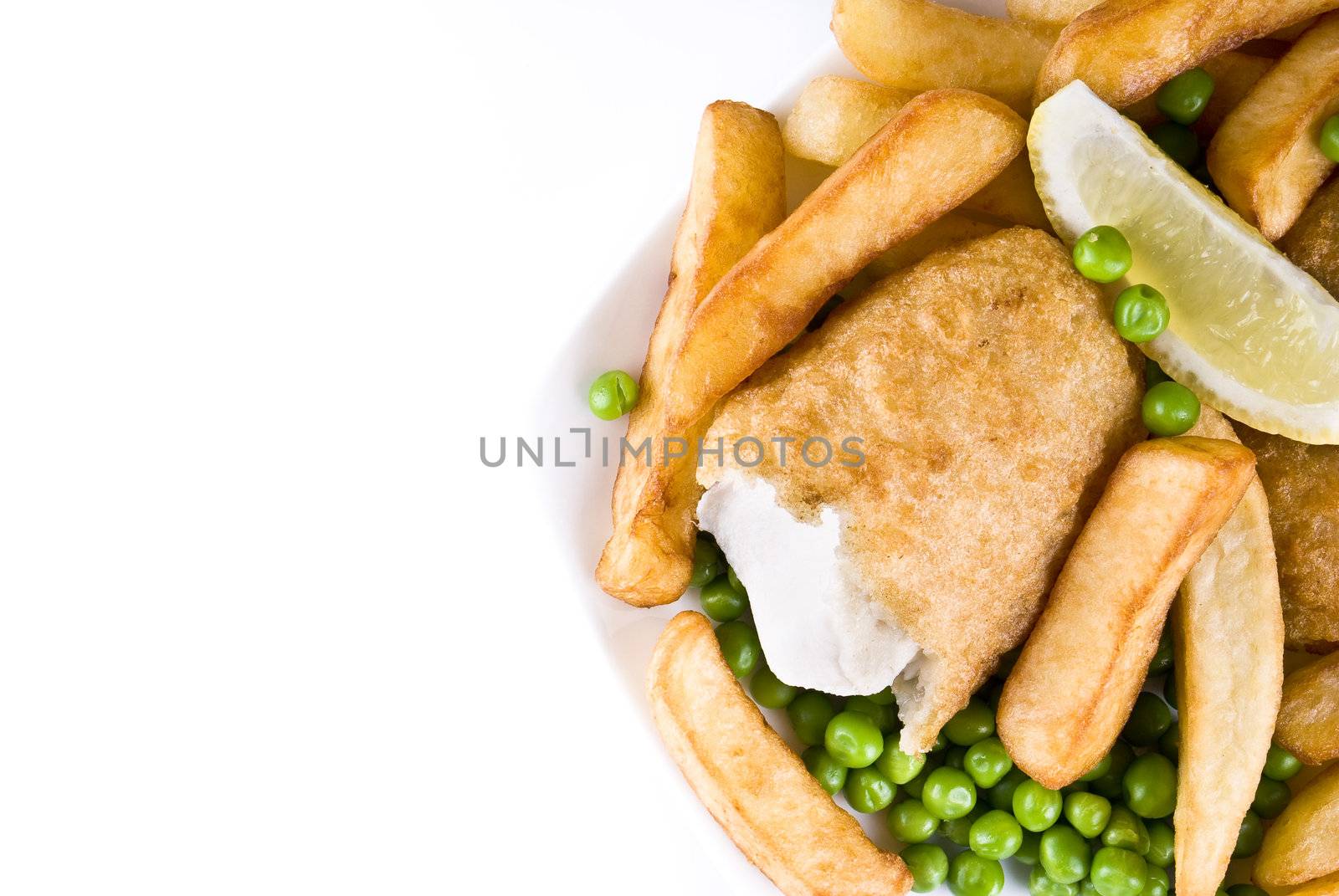 Fried fish and chips with lemon and peas - isolated