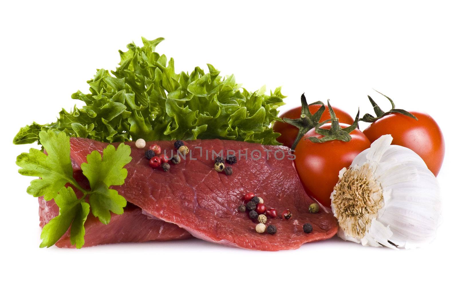 Raw beef frying steak with vegetables isolated over white background