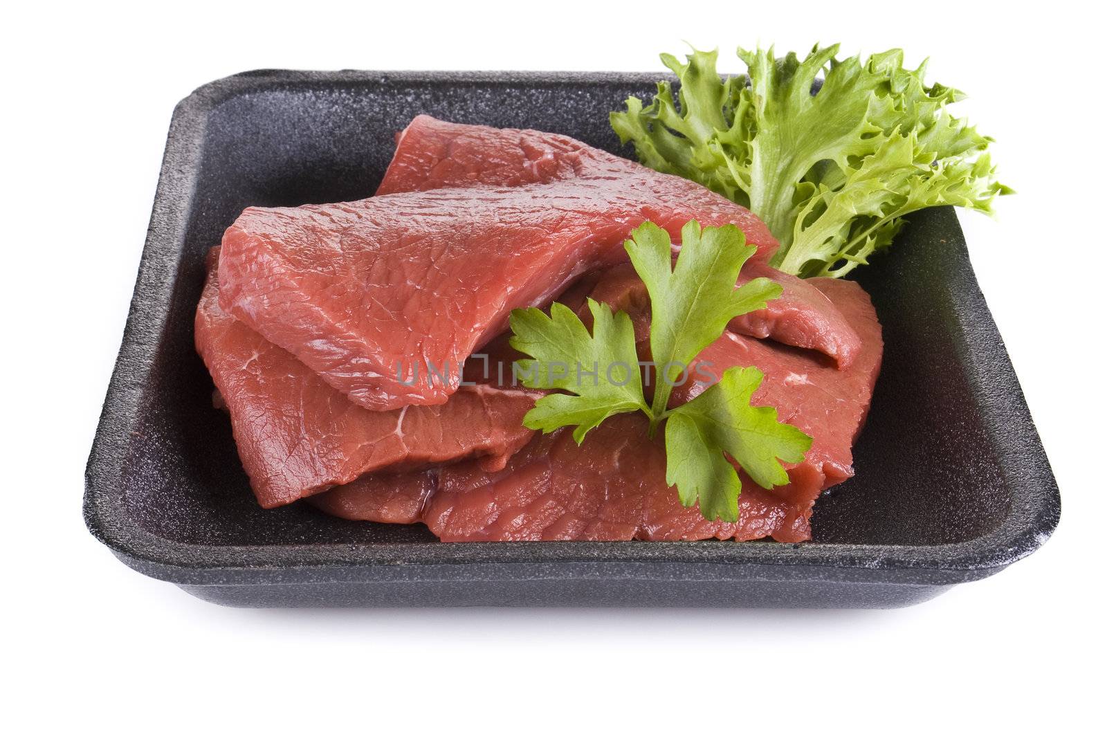 Raw beef frying steak in black tray  isolated over white background