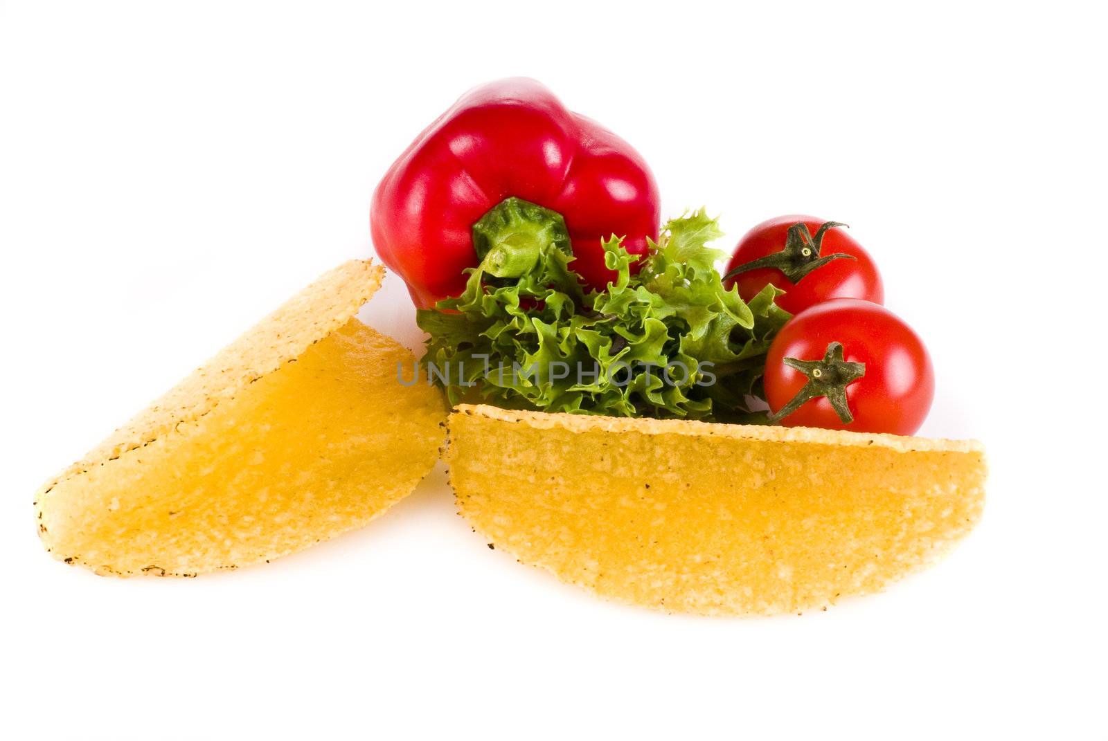 Taco shells with vegetables isolated over white background