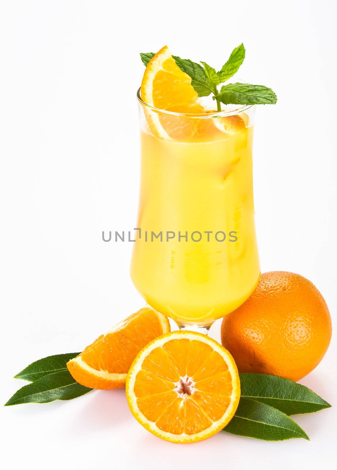 Orange juice with the pieces of orange in the glass - isolated