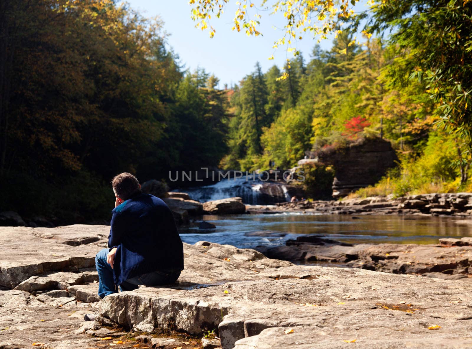 Lady watching the upper falls in Swallow Falls State Park in Maryland USA