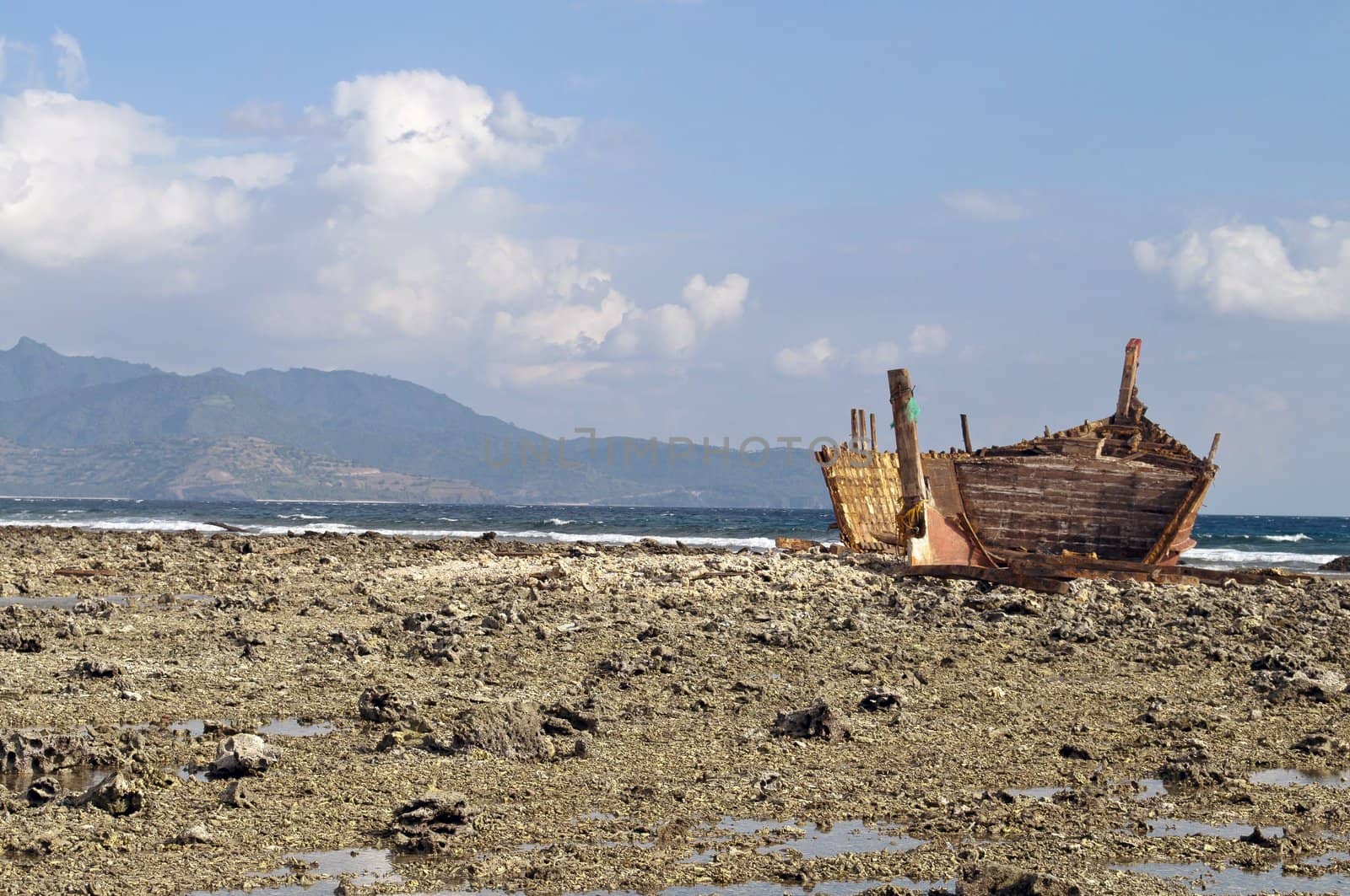 Old rusty shipwreck in low tide coastline