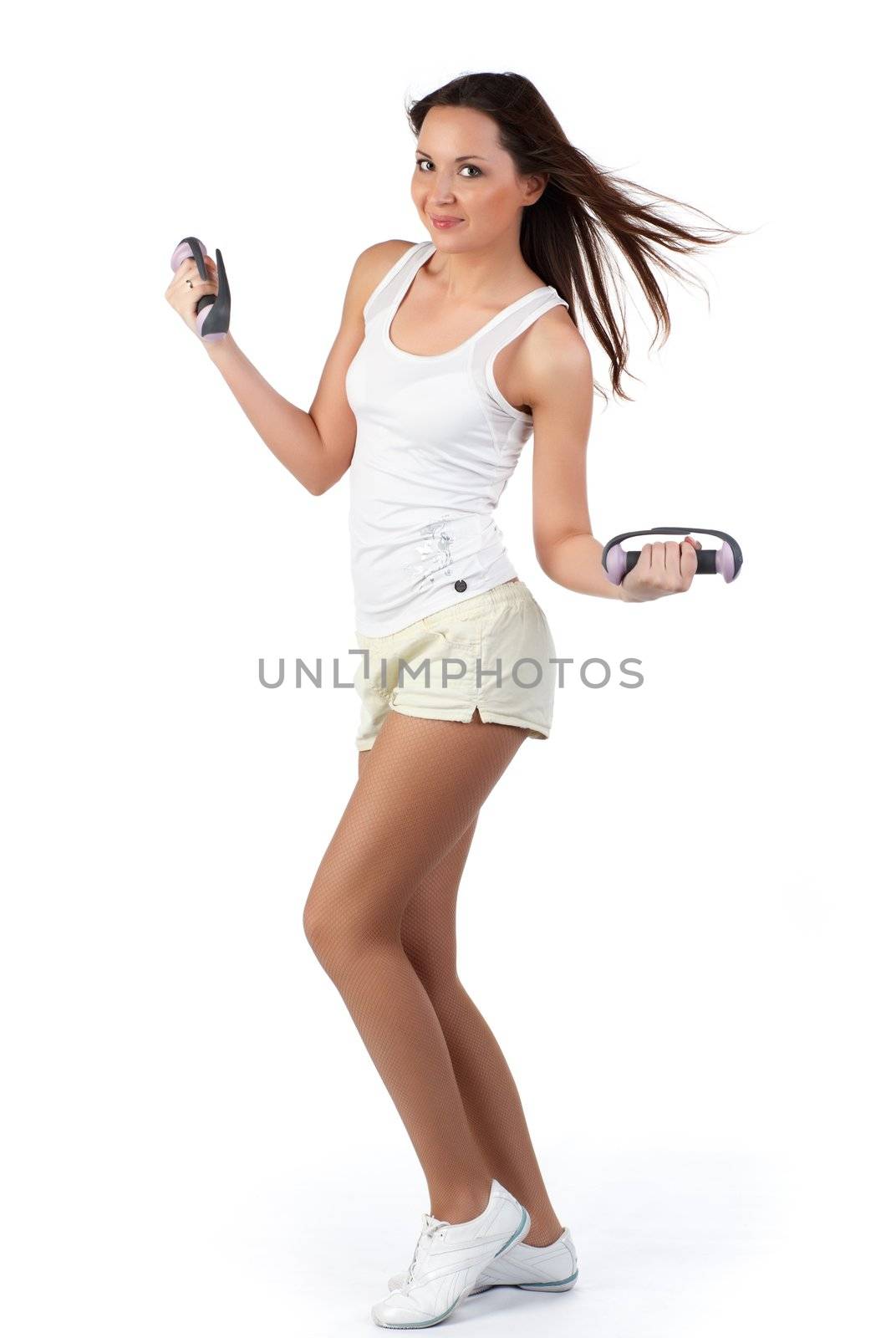 A woman carries athletic exercise with dumbbells