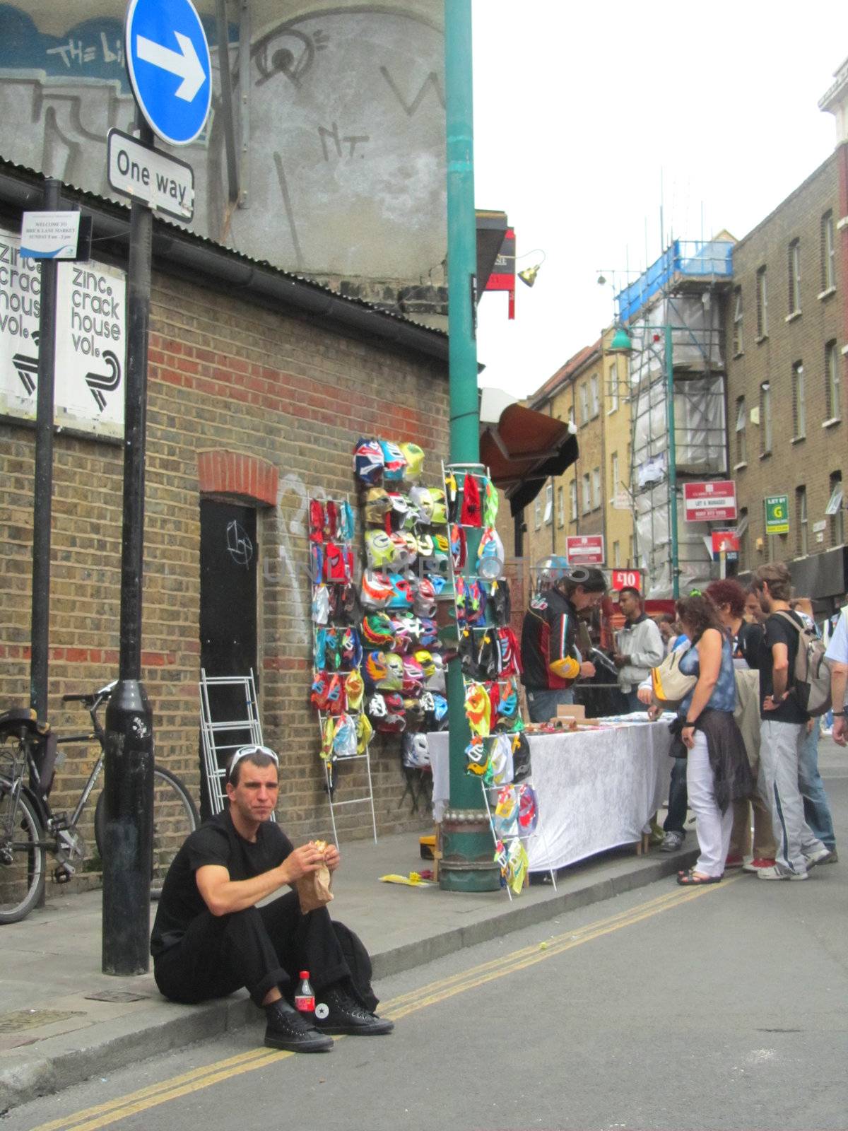 LONDON - AUGUST 15: Unidentified visitors at Brick Lane Market on August 15, 2010 in London. Brick Lane Market is one of the largest multicultural Sunday markets in London.                 