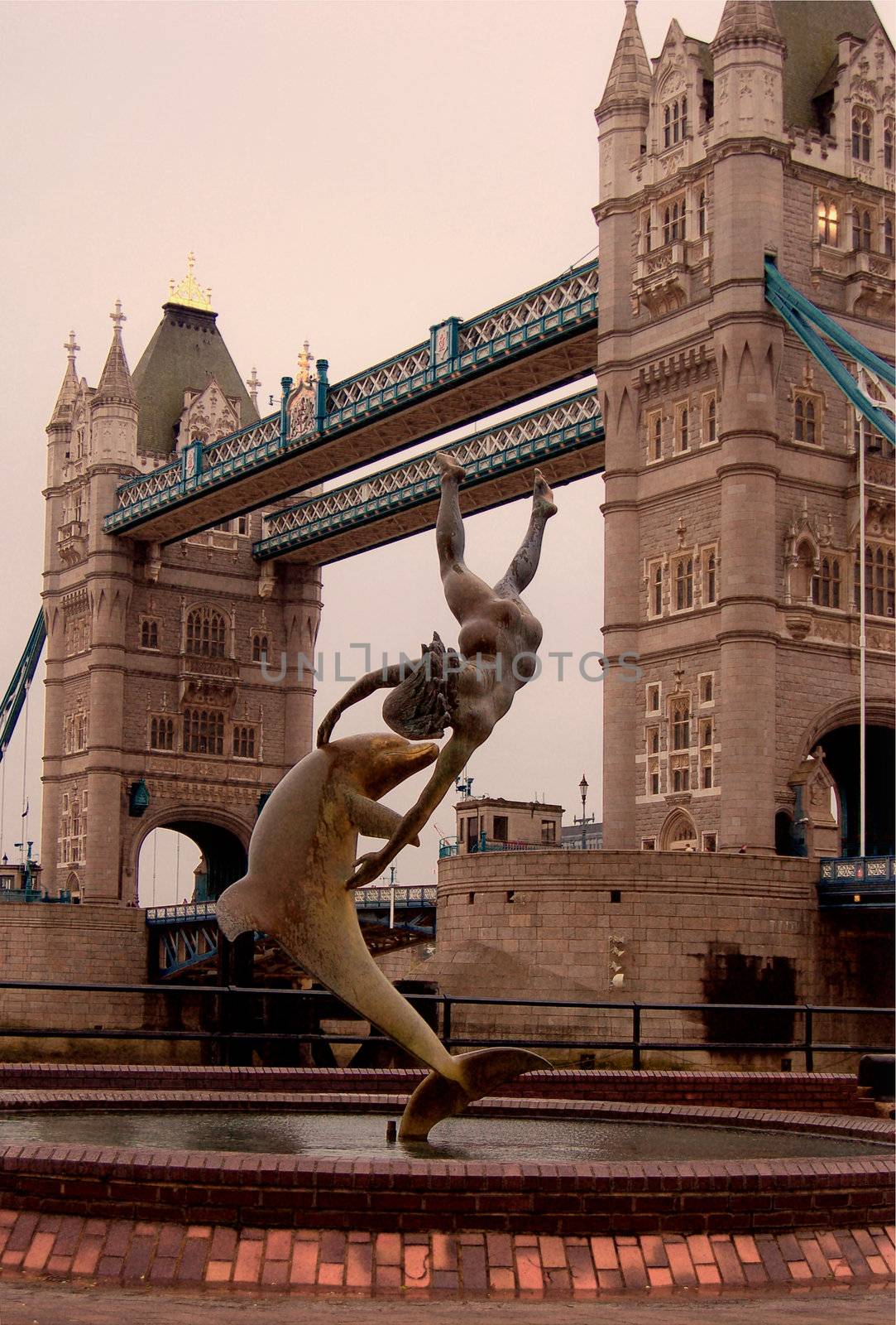 Tower Bridge in London, England. Statue of girl and dolphin.