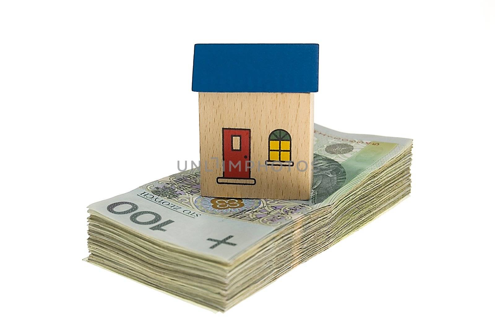 Real estate concept - House on stack of polish zlotys isolated