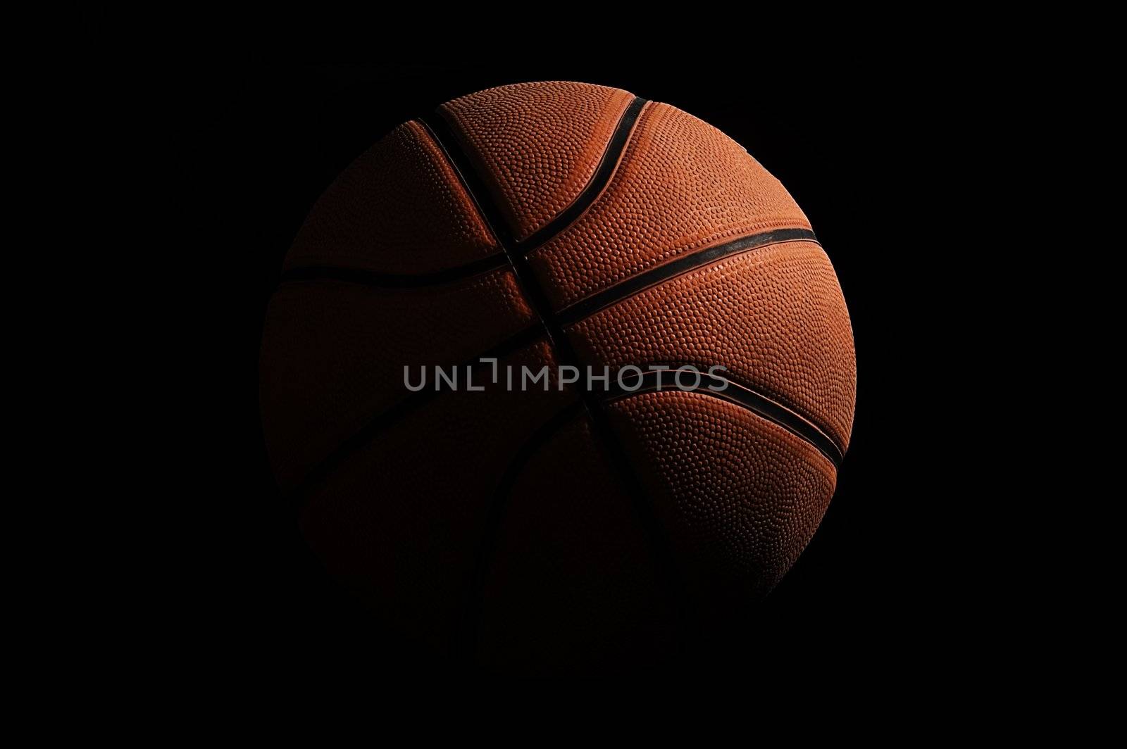 Basketball over black background by johnnychaos