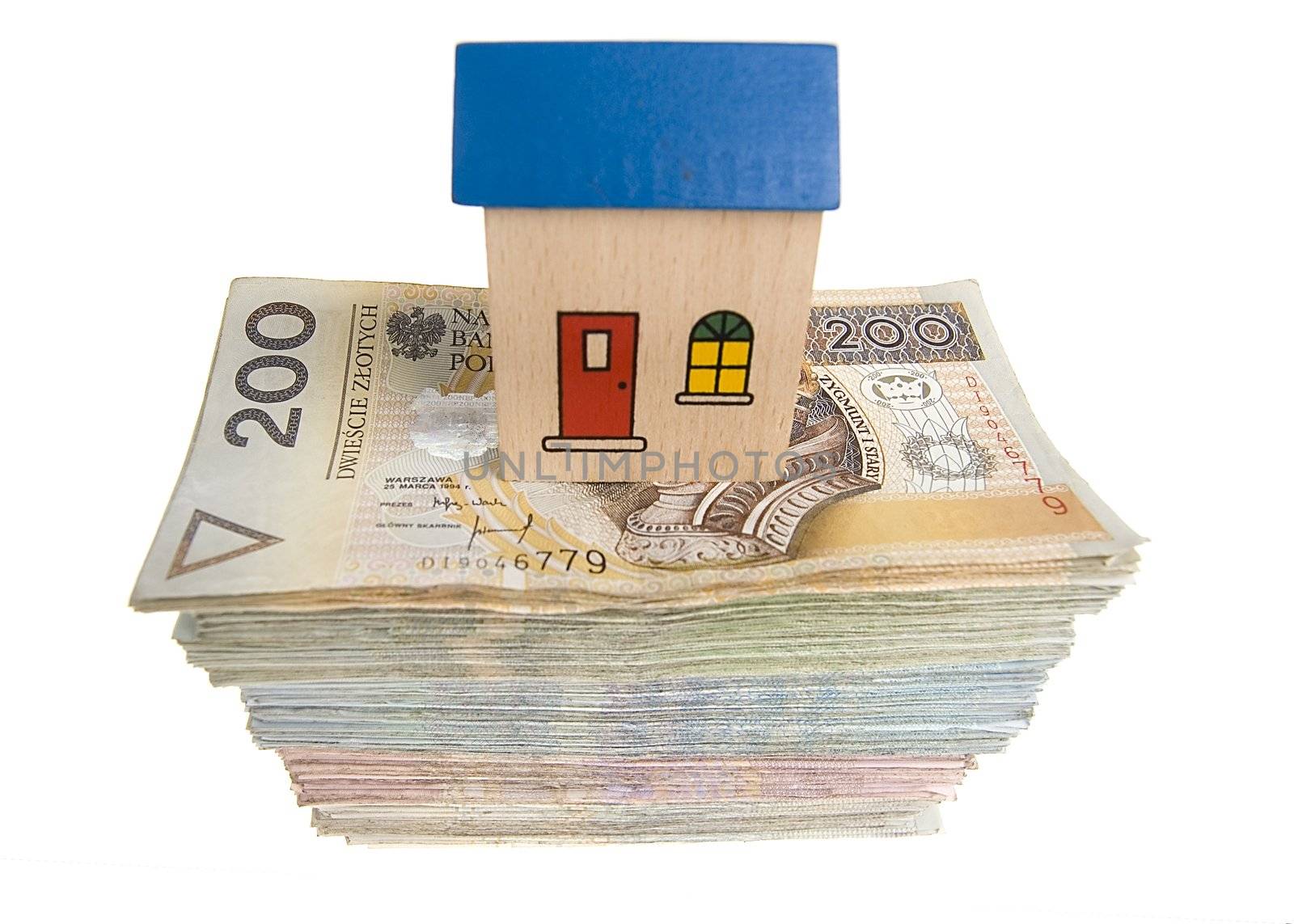 Real estate concept - House on stack of polish zlotys isolated