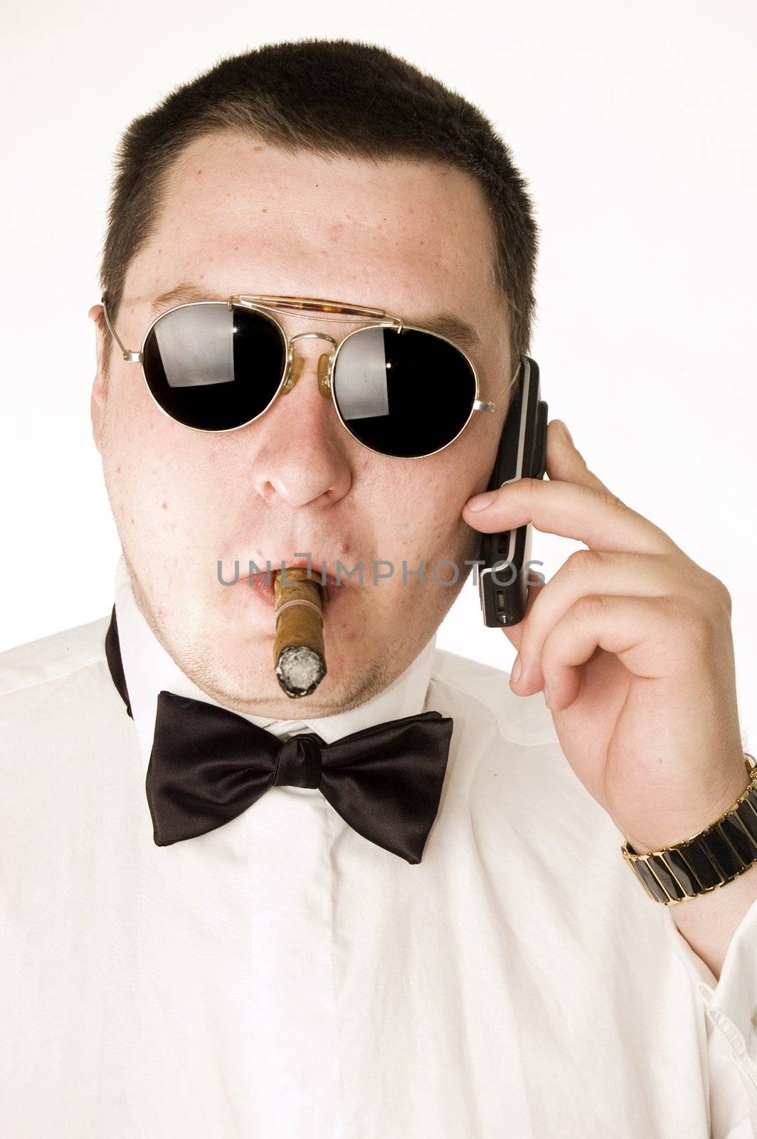 Macho man with cigar and sunglasses talking on cellphone