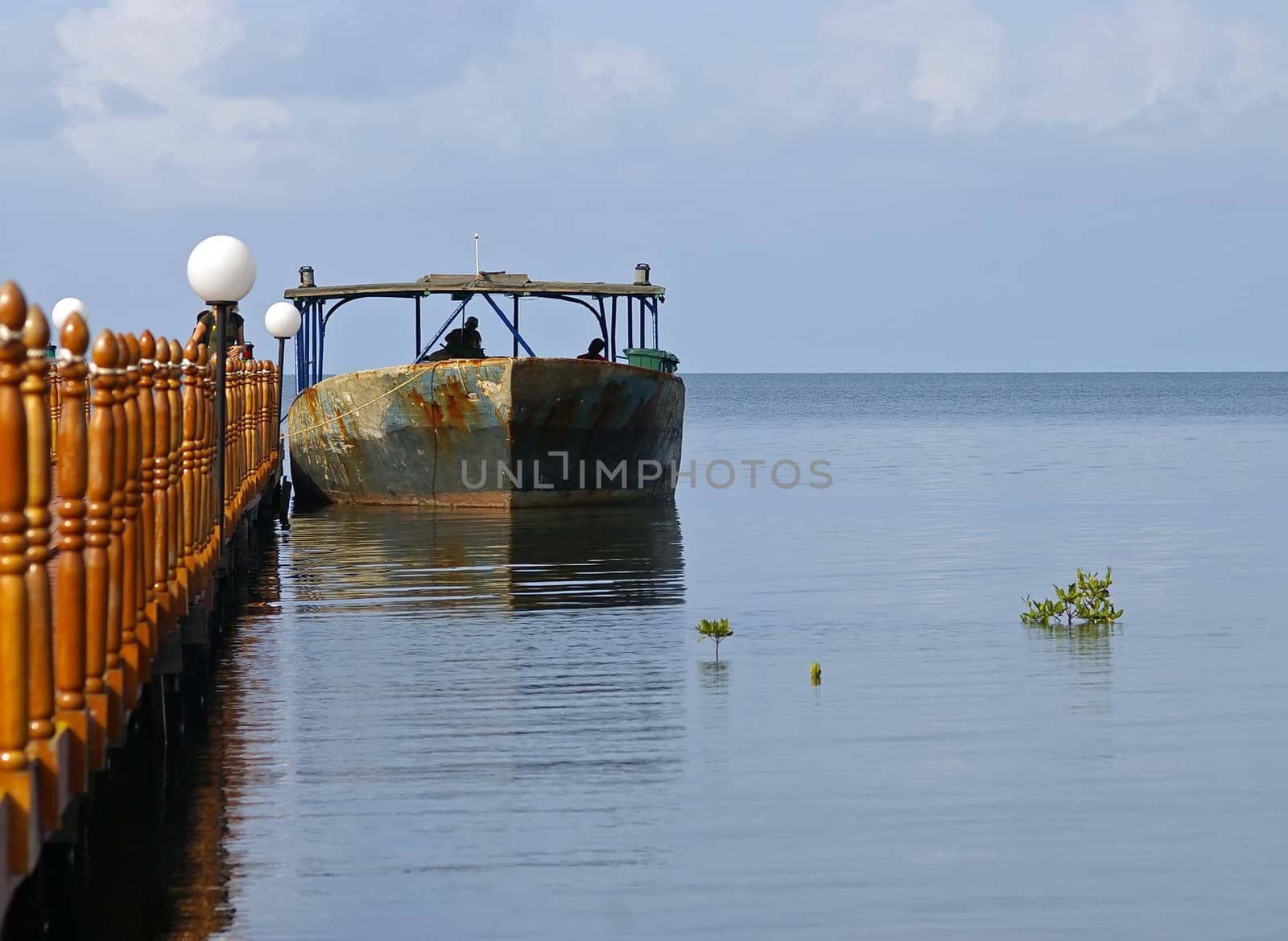 Old boat tied to a jetty in Cuba by baggiovara