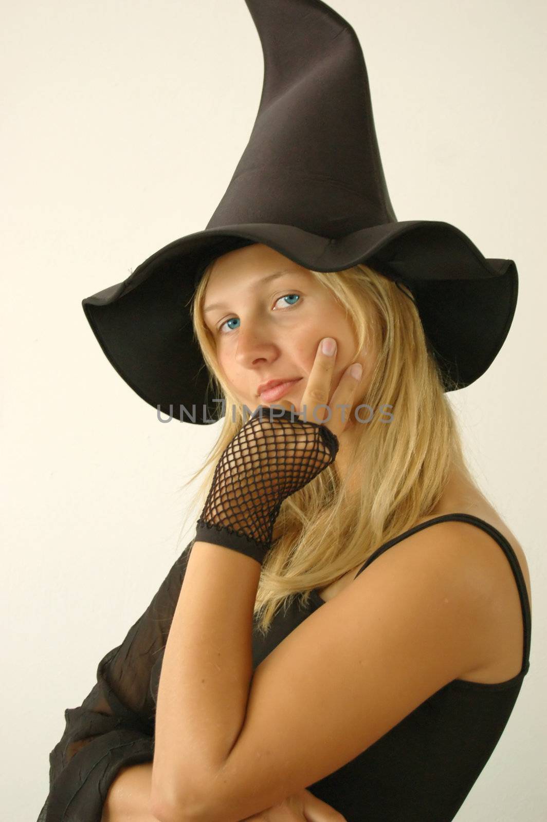 Pretty young witch. She put a spell on you :)
Party, Carnival and Halloween concept.