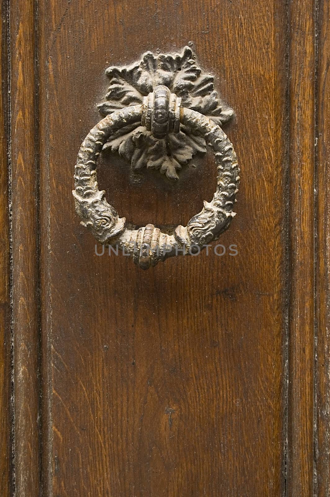 old knocker on weathered wooden door