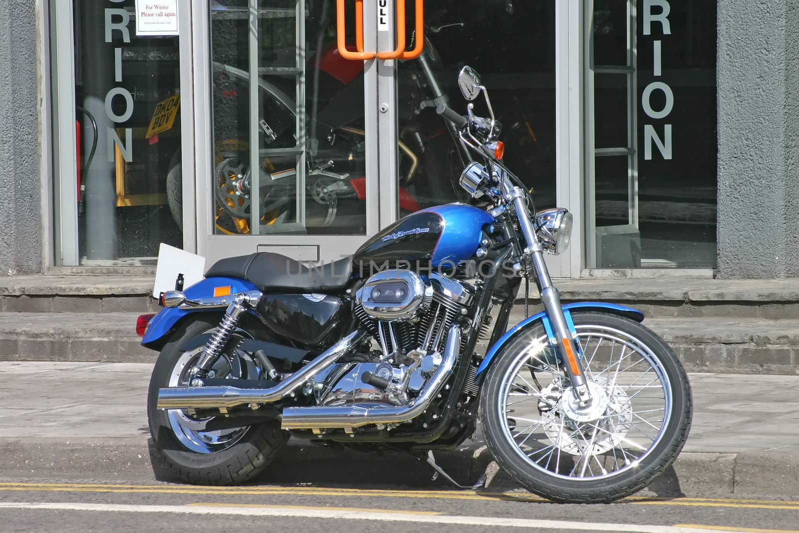Blue and Black Harley Davidson Motor Bike Parked
