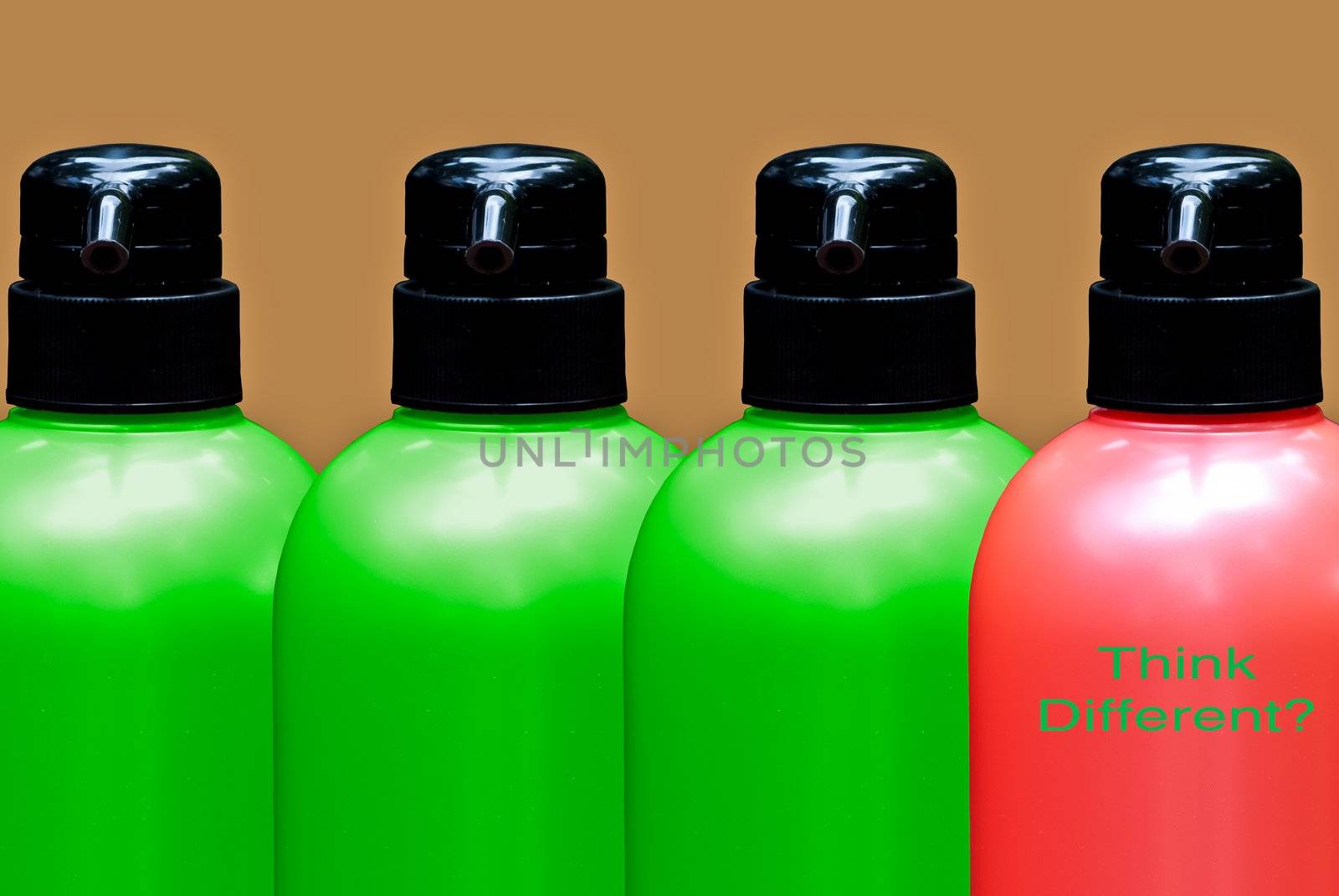 Colourful bottles put together on a brown background with one bottle different color then others with 'think different' text
