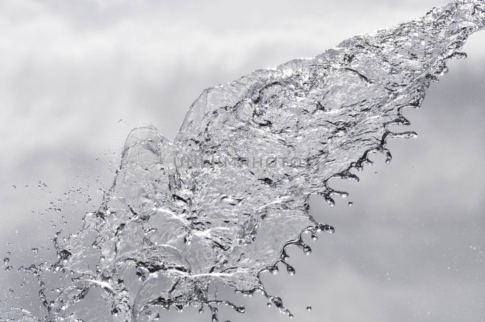 Water splash on a cloudy sky background