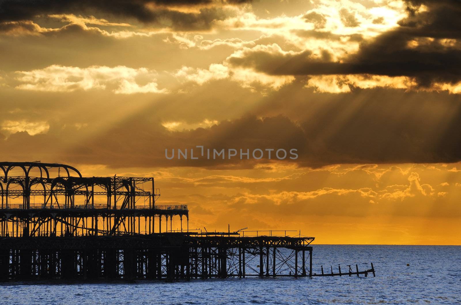 The West Pier in Brighton at sunset by dutourdumonde