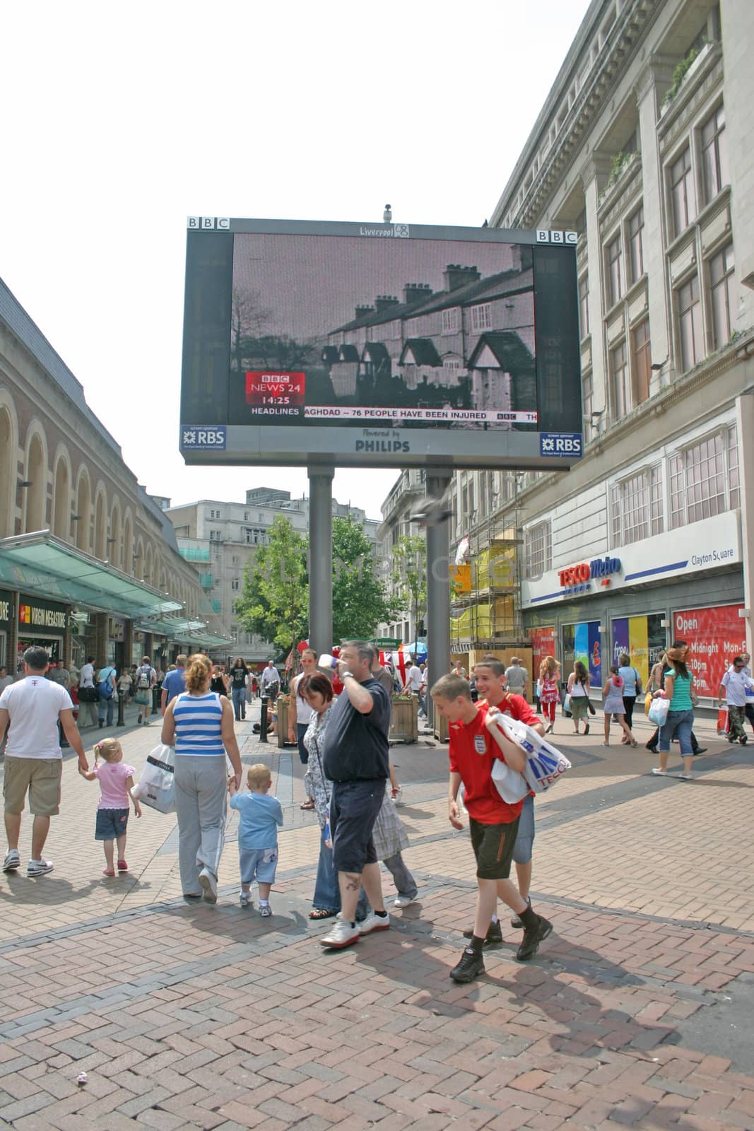 Tourists and Shoppers in  Front of Big Screen in Liverpool UK by green308