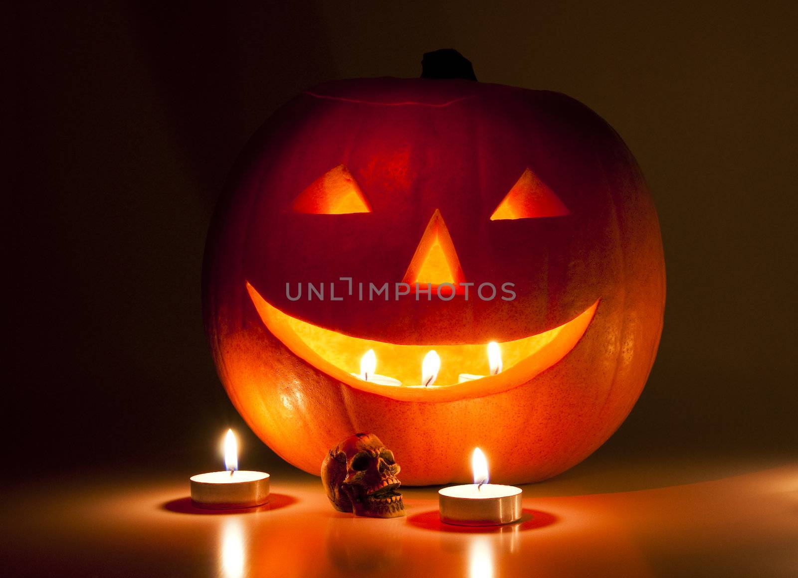Halloween lantern and a small skull lit by candles