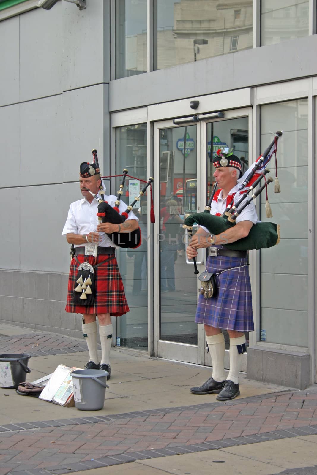 Two Scotsmen in Kilts Playing Bagpipes in Liverpool by green308