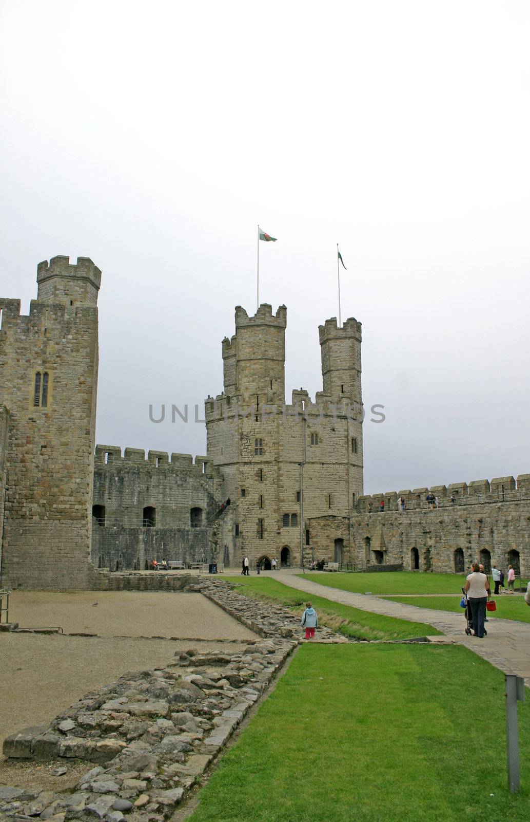 Tourists at Caernarfon Castle in North Wales UK