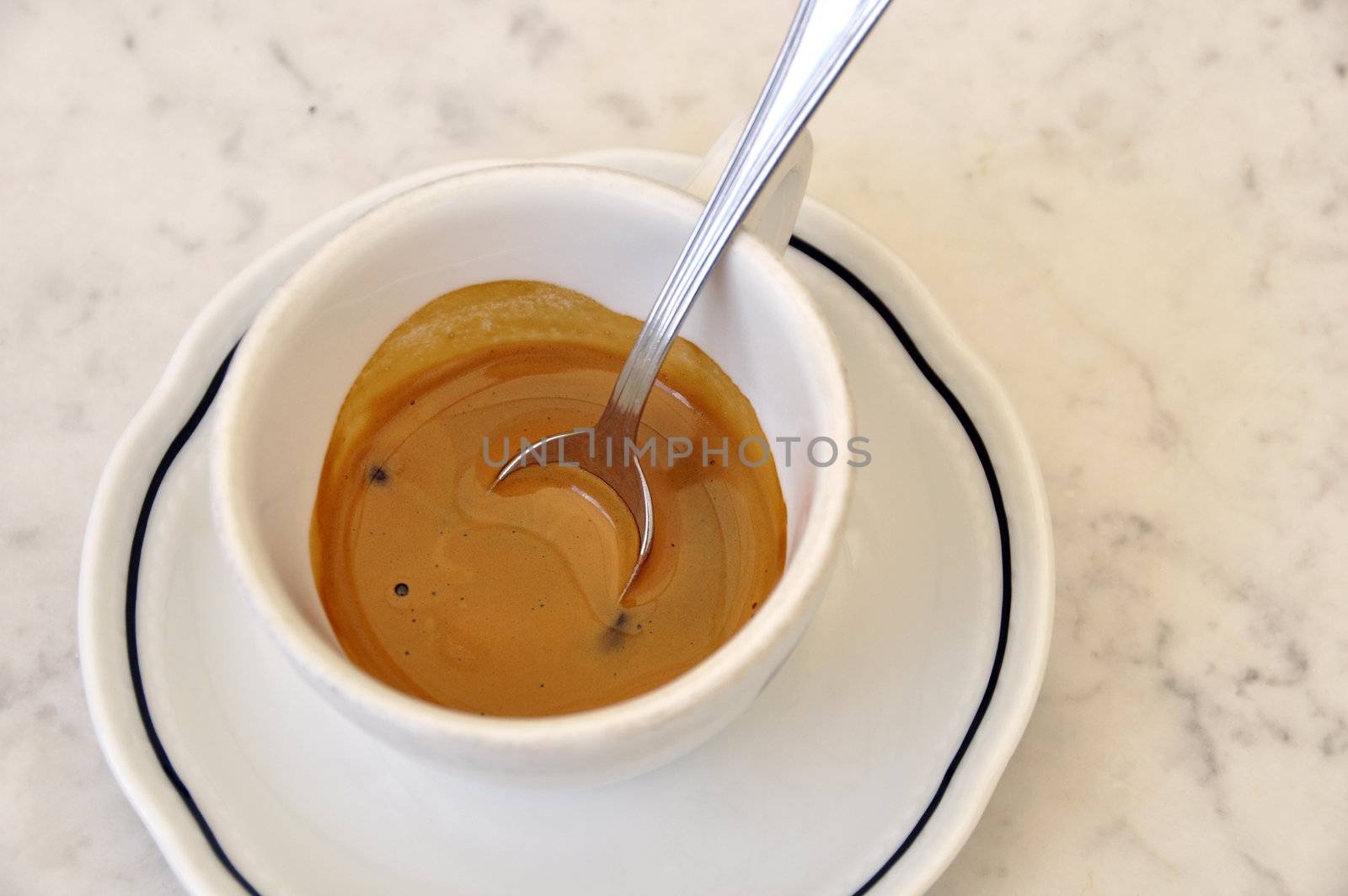 An espresso cup on a marble table