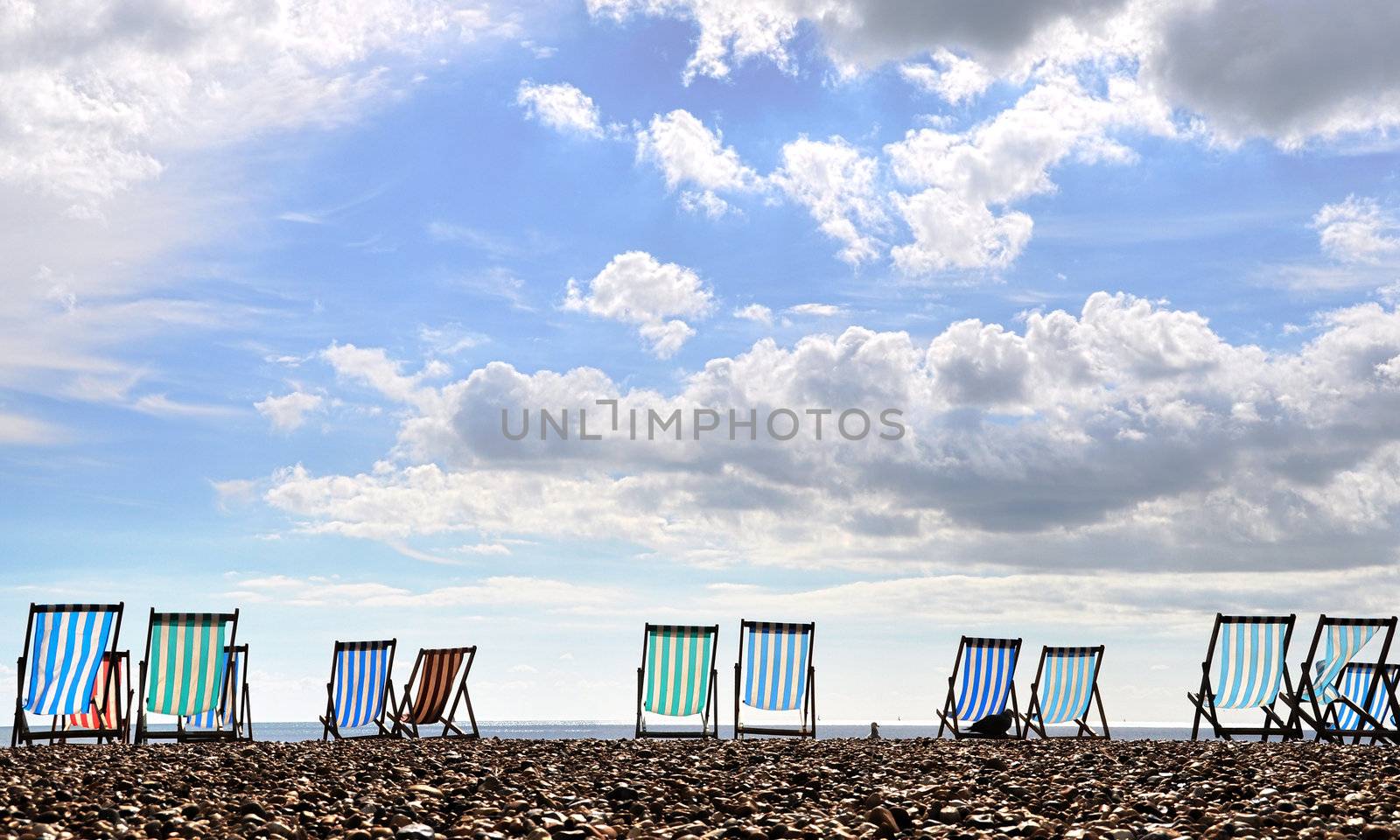 Deckchairs on Brighton beach by dutourdumonde