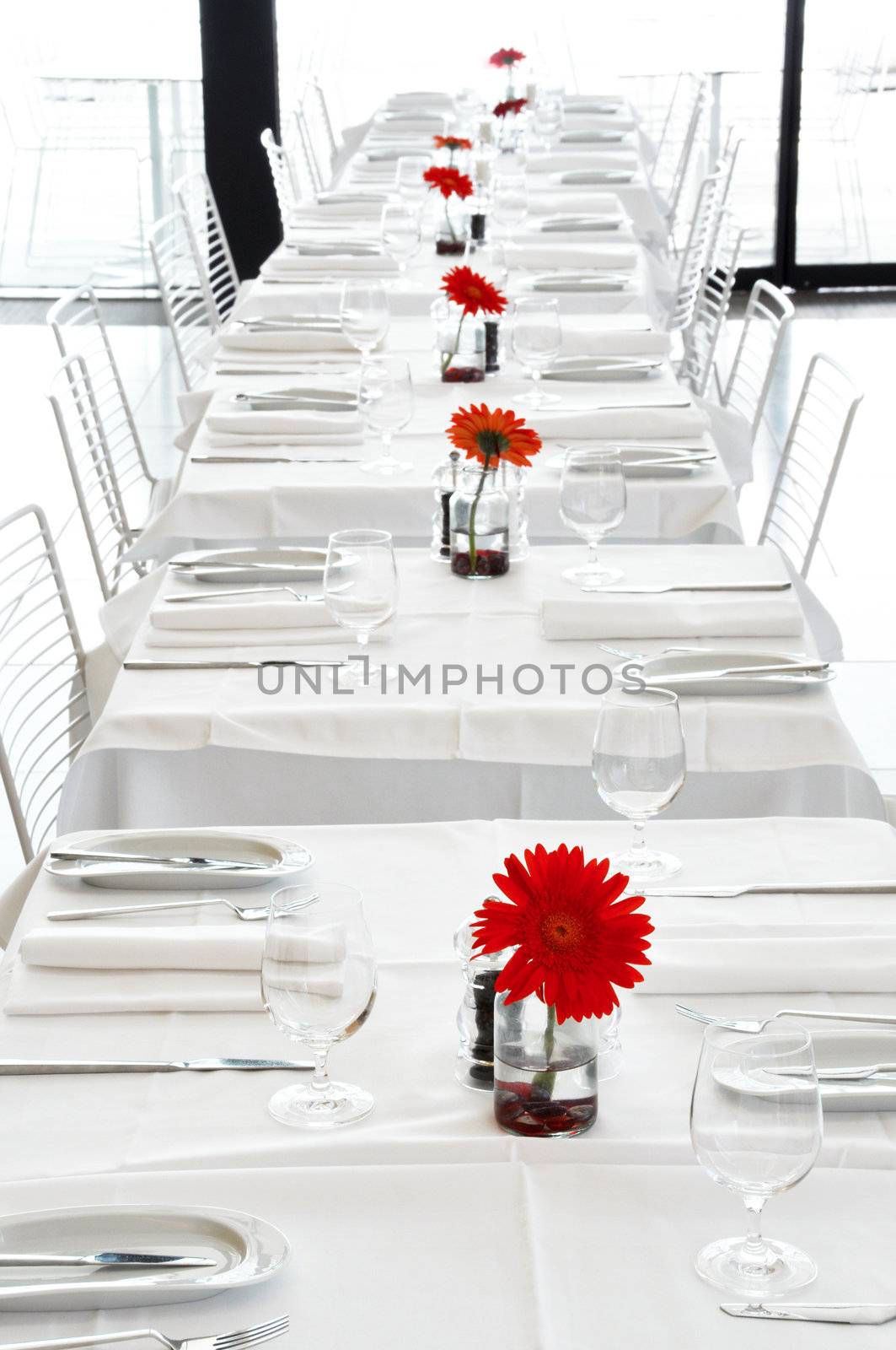 A white restaurant with red flowers