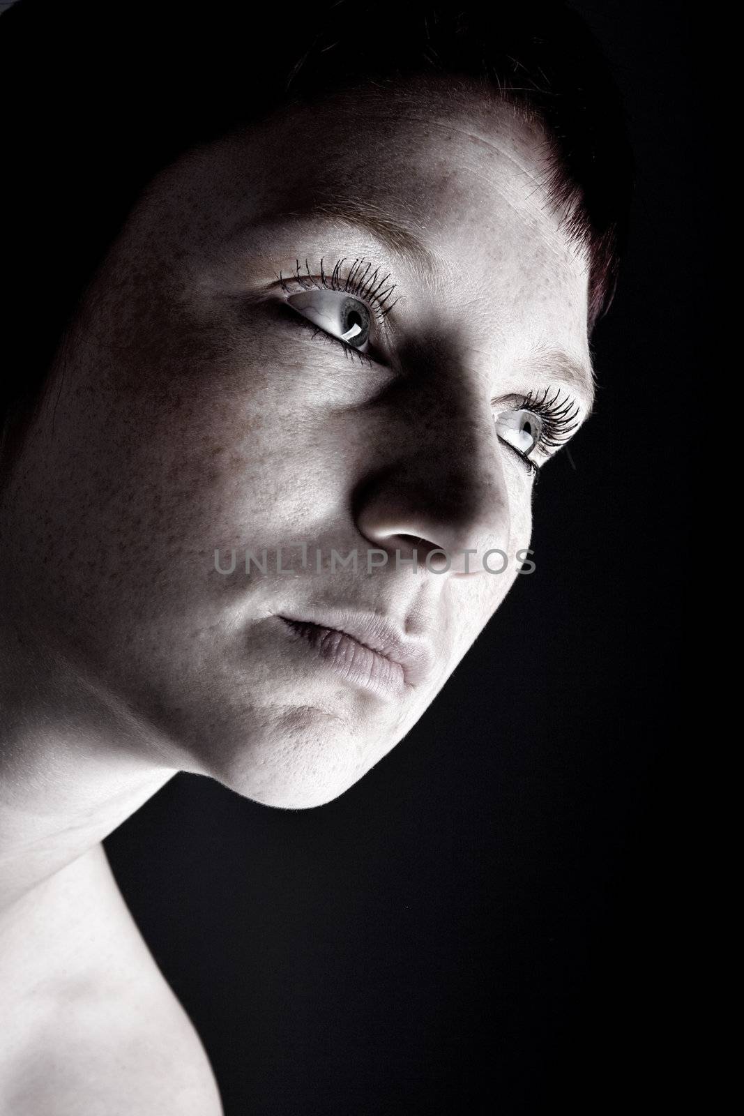 Studio portrait of a young woman with short hair in the dark by DNFStyle