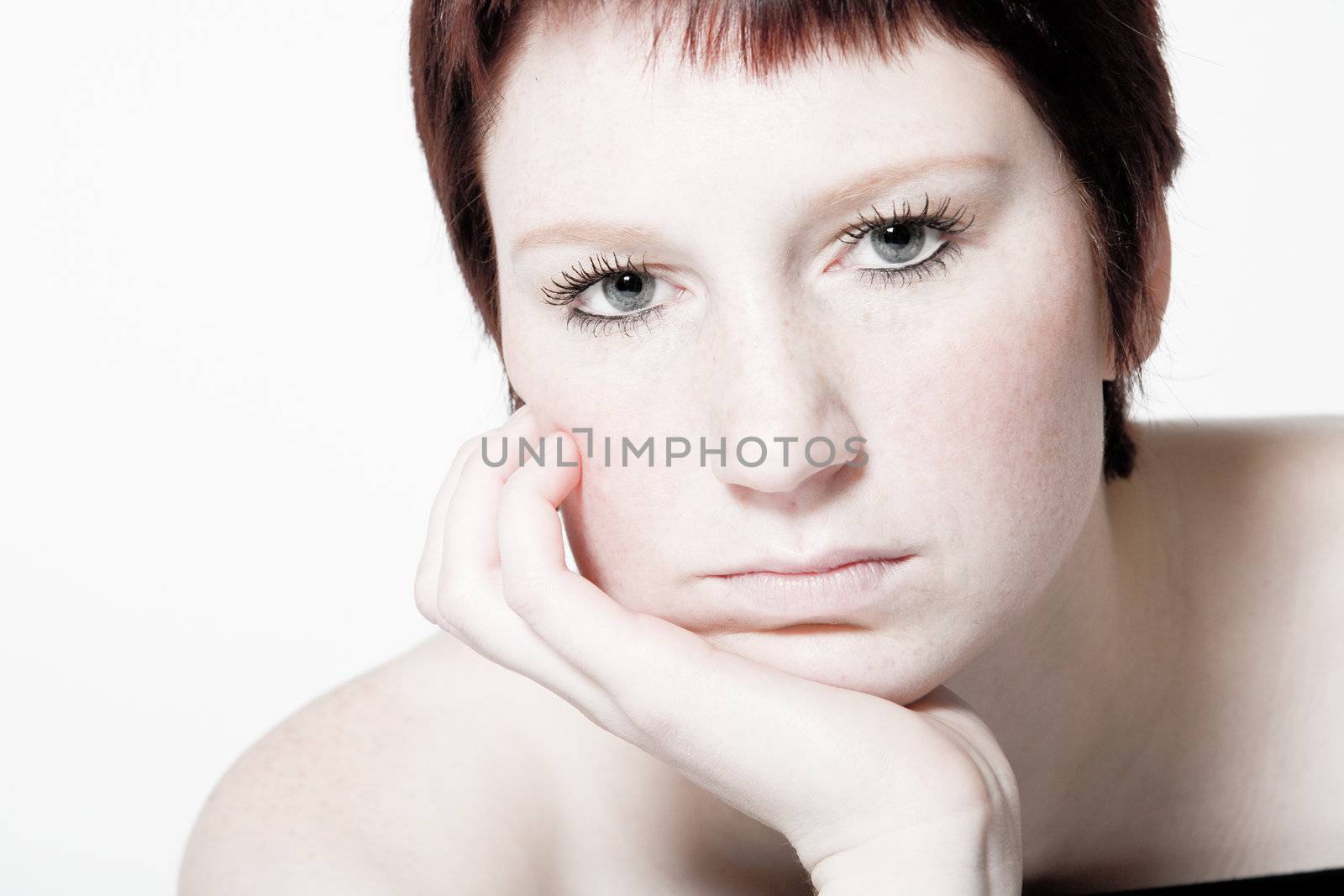 Studio portrait of a young woman with short hair looking uninterested