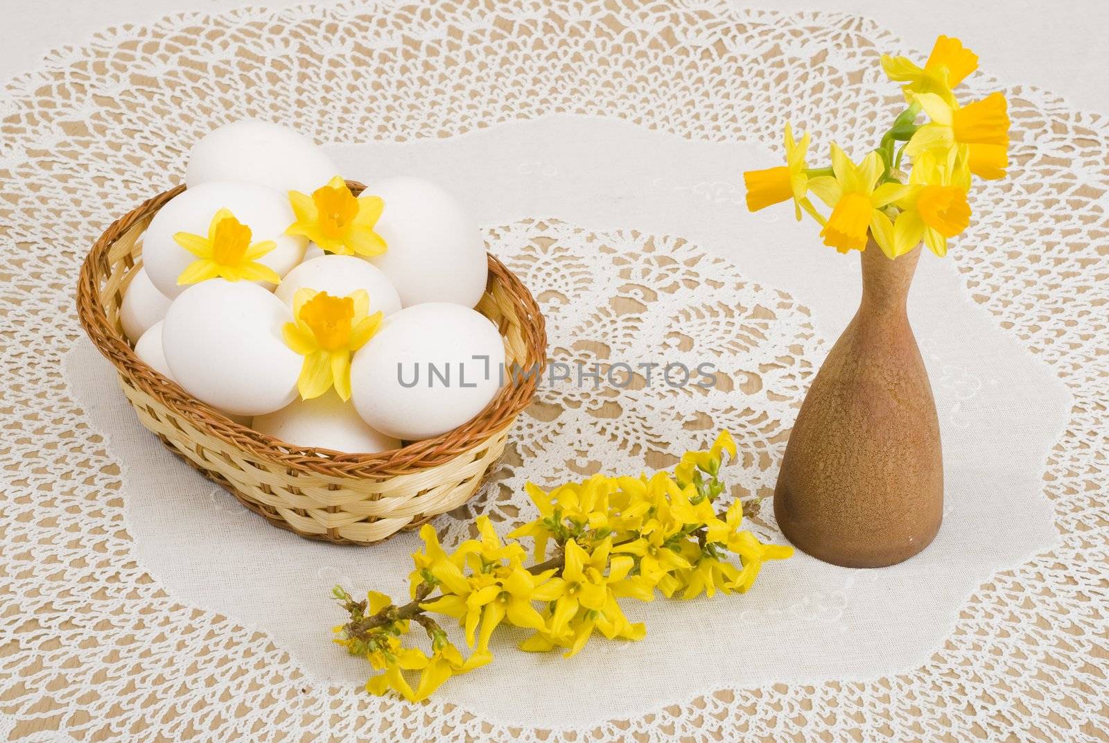 a basket of eggs, forsythia and yellow daffodils