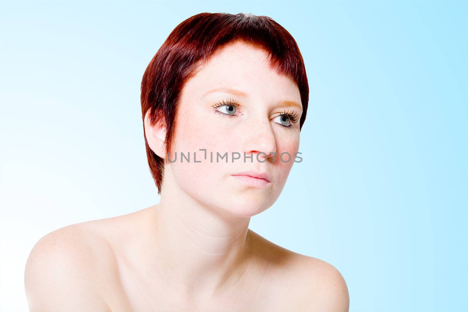 Studio portrait of a young woman with short hair looking bored