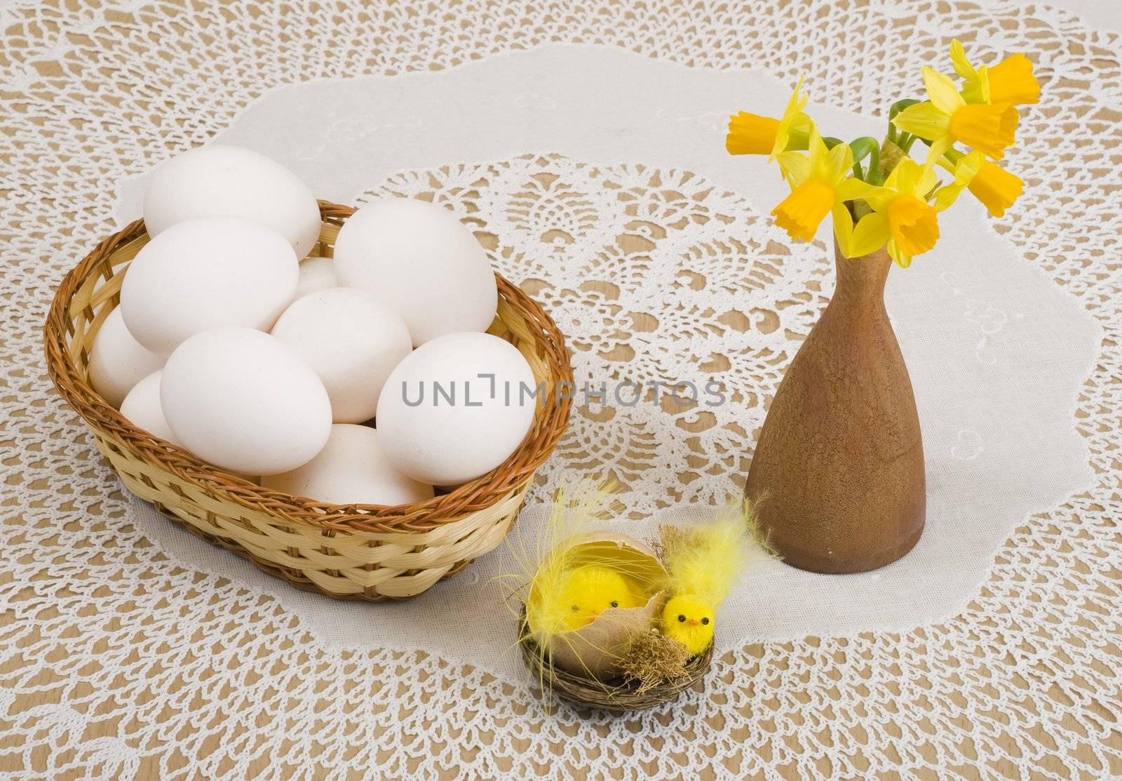 a basket of eggs, easter chicken and yellow daffodils