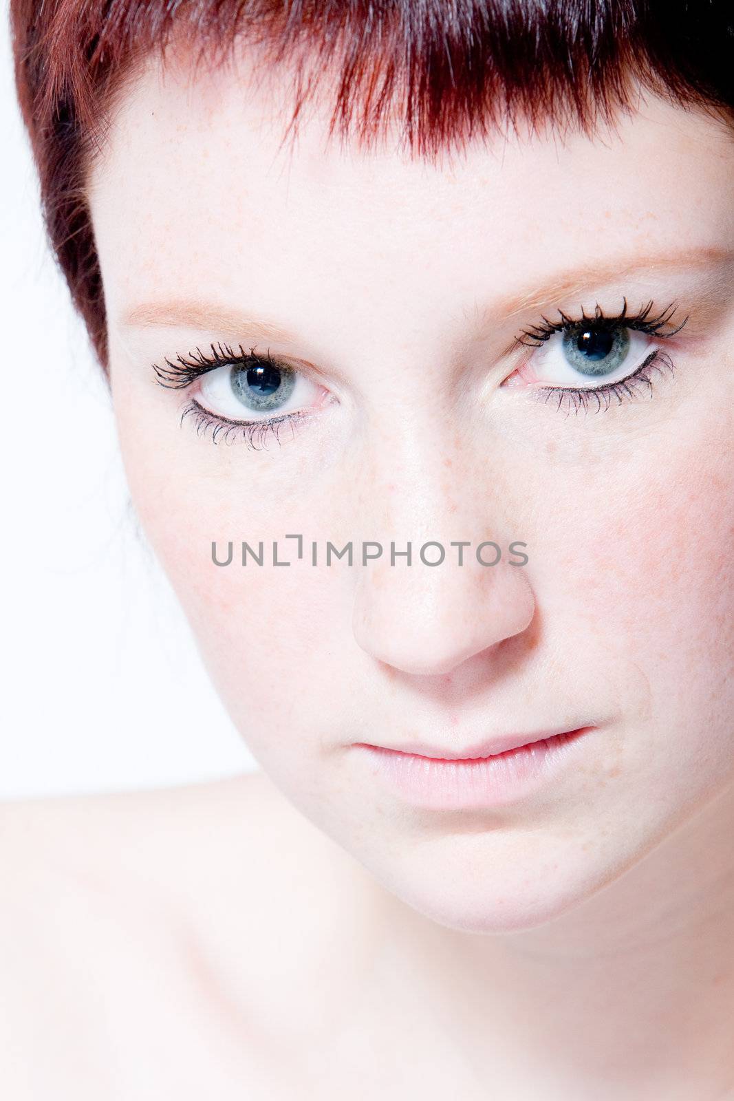 Studio portrait of a young woman with short hair making eye contact