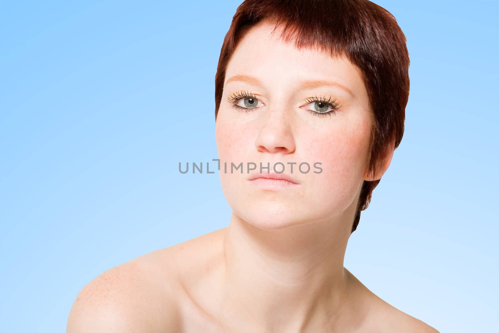 Studio portrait of a young woman with short hair looking uptight