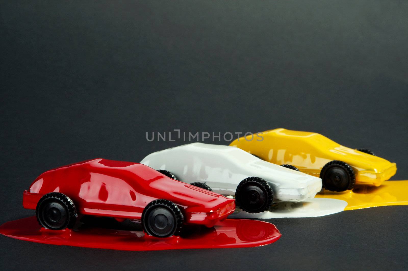 Small copies of sports automobiles filled with a paint