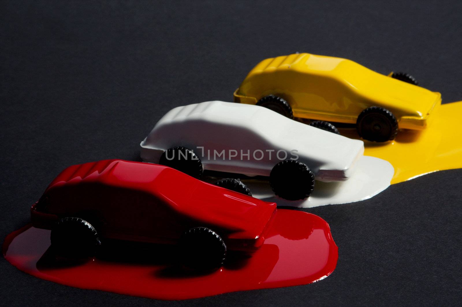 Small copies of sports automobiles filled with a paint