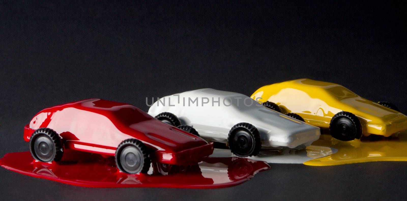 Small copies of sports automobiles filled with a paint