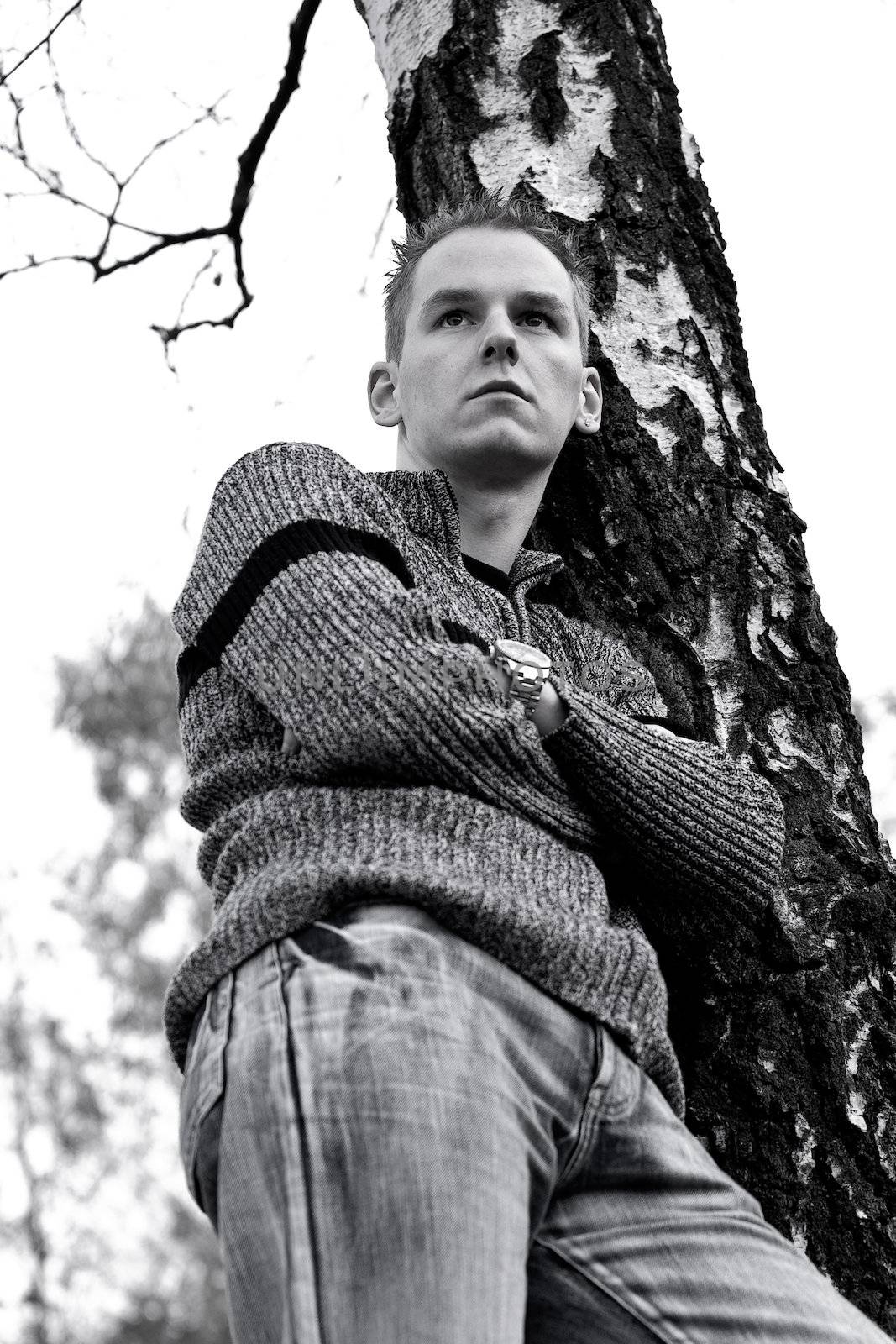 Boy in front of a dead tree