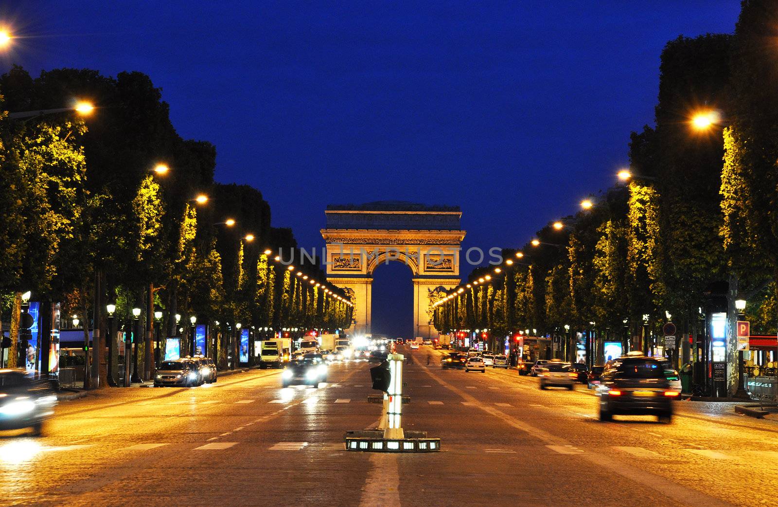 The Champs-Elysees at night in Paris, France