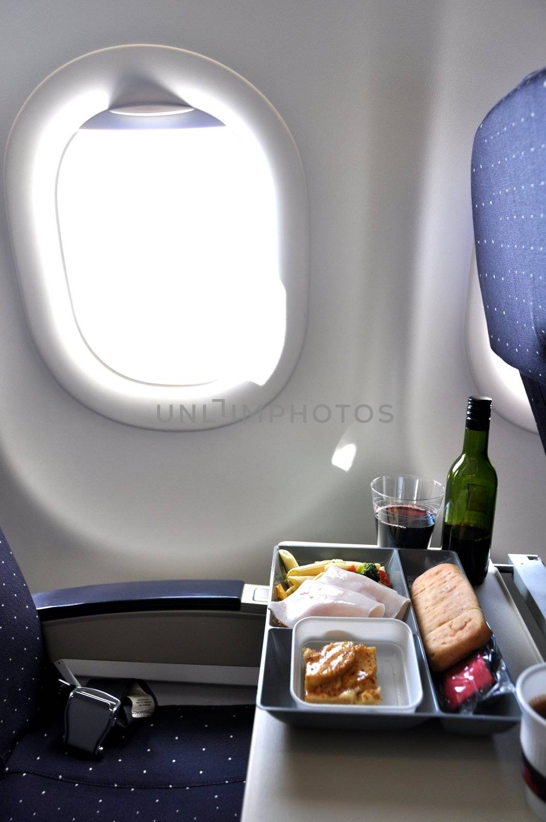 Lunch tray and bottle of wine in an airplane
