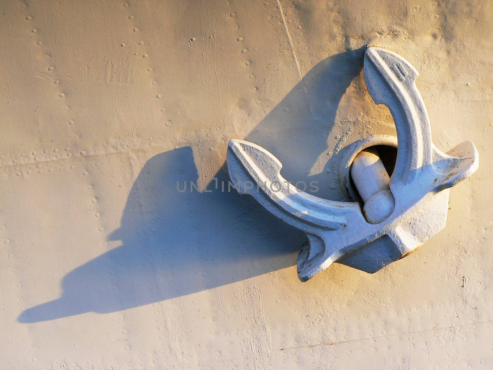 Close up of a white anchor at sunset