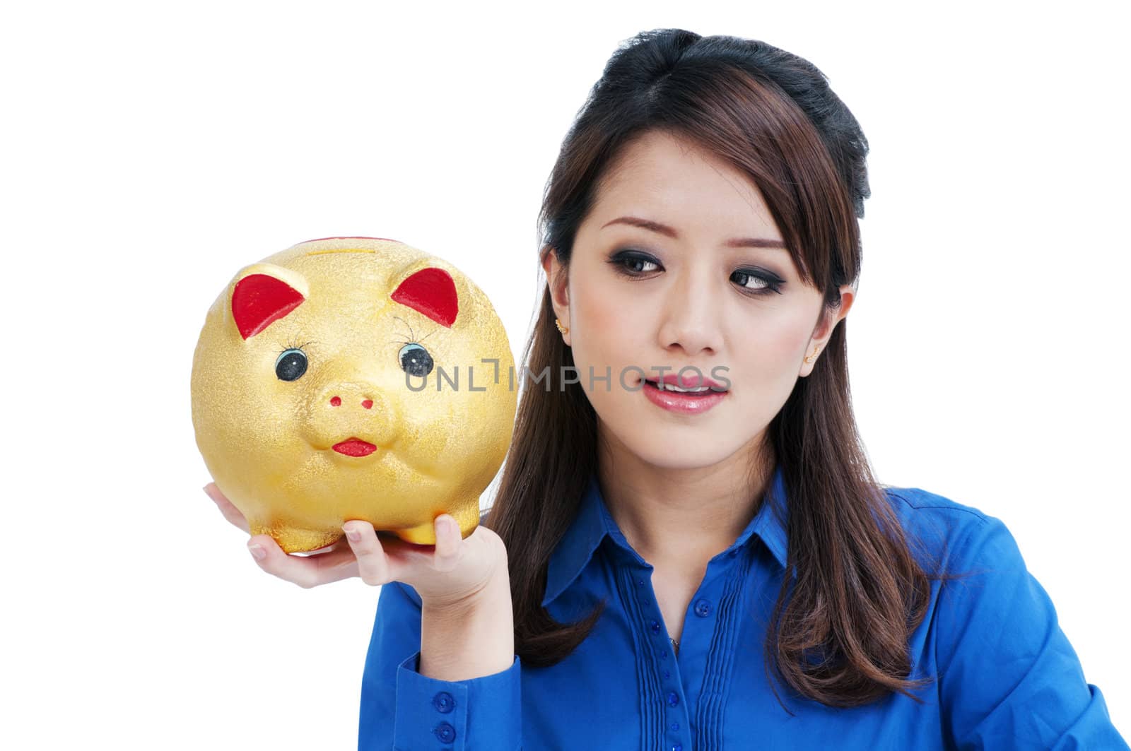 Portrait of a beautiful young woman holding piggy bank against white background.